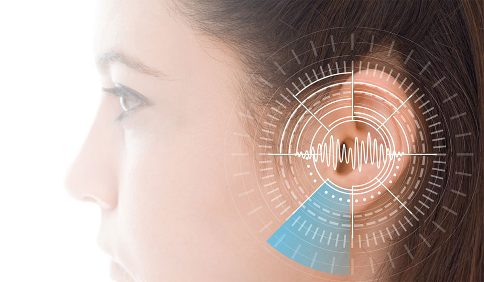 Close-up of a girl’s ear with soundwave graphics and a circular visual representation of hearing range.