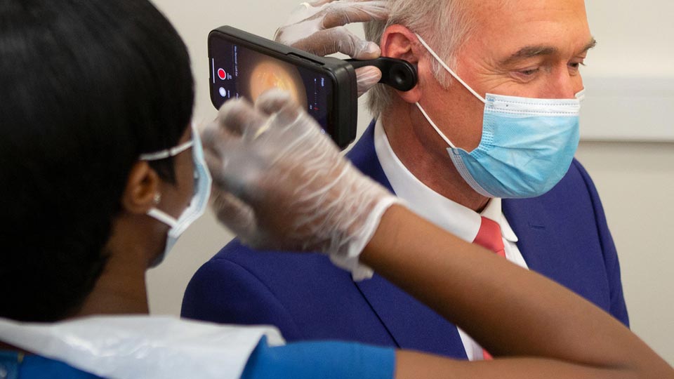 Dr Hilary Jones demonstrating ear wax removal with modern diagnostic tools