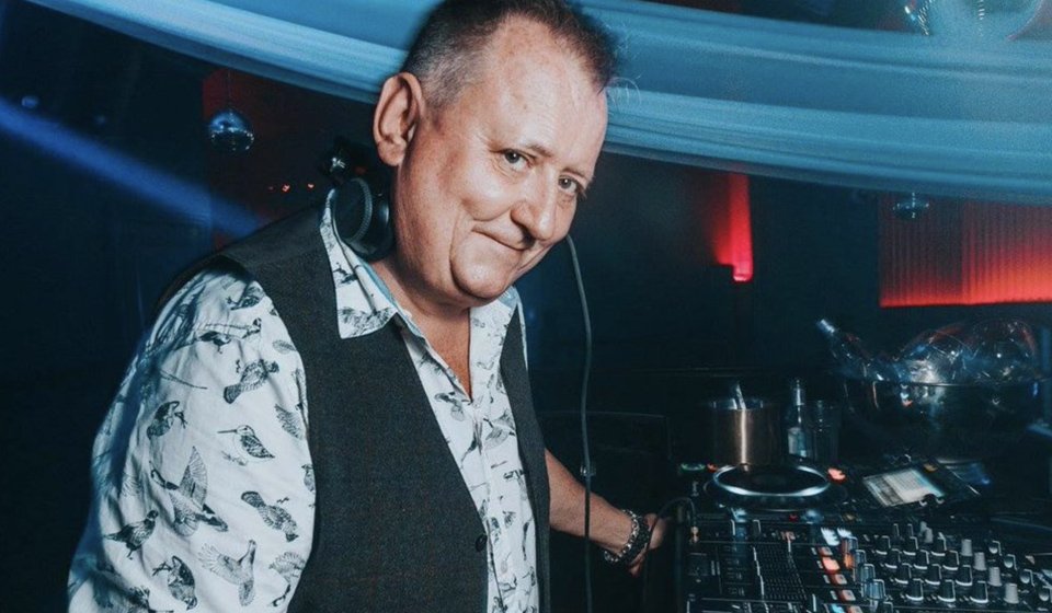 DJ wearing hearing aids while performing at a nightclub.