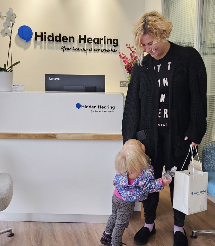 A lady receives her new hearing aids which will help her after suffering from hearing loss and tinnitus 