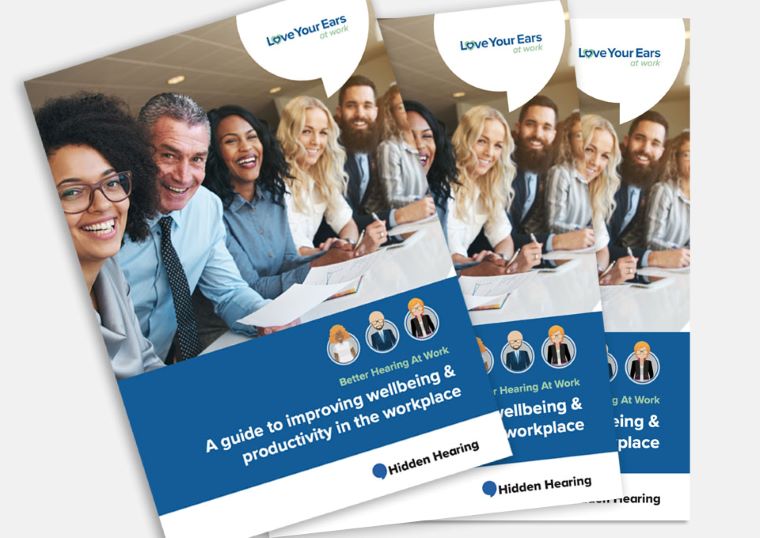 Brochures titled 'Better Hearing At Work: A guide to improving wellbeing & productivity in the workplace' with Hidden Hearing branding and 'Love Your Ears at Work' slogan, featuring blurred individuals in a workplace setting.