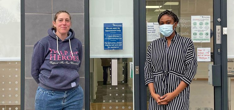 Tracey White standing with a hearing care professional outside a clinic.