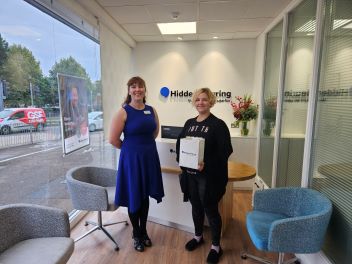 A lady receives her new hearing aids which will help her after suffering from hearing loss and tinnitus 