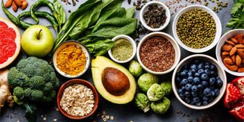 Nutrient-rich foods that support hearing health, including fruits, vegetables, nuts, and seeds.