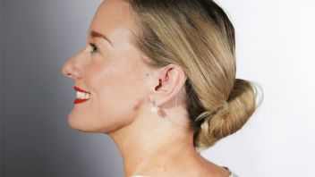 Lady with blonde hair wearing a DeafMetal hearing aid earring accessory