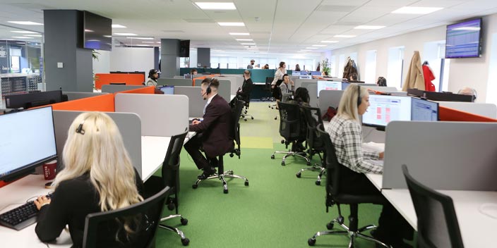 Hidden Hearing call centre employees working in an open-plan office in Nottingham.