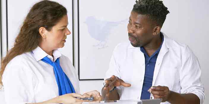 Hearing care specialists discussing hearing aids in a professional setting