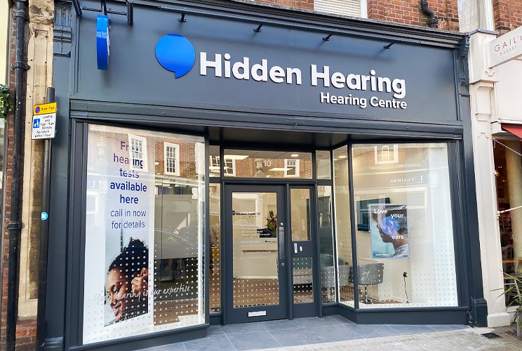 Hidden Hearing storefront with signage promoting free hearing tests and hearing care services.