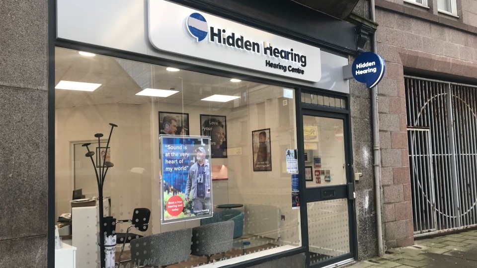 Hidden Hearing Aberdeen clinic storefront with clear signage and glass windows displaying posters.