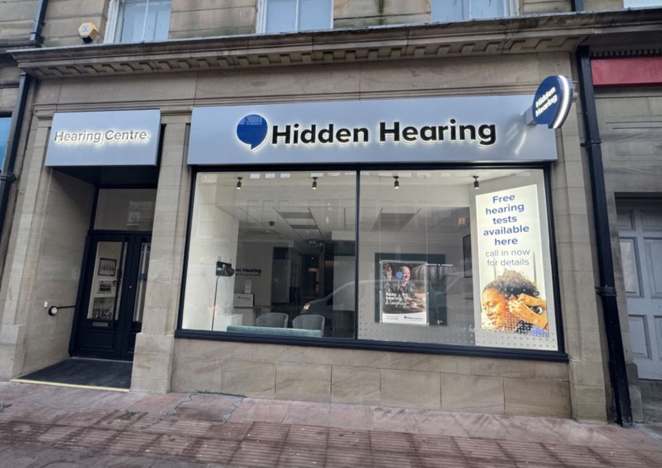 Hidden Hearing Carlisle clinic exterior with signage displaying free hearing test information