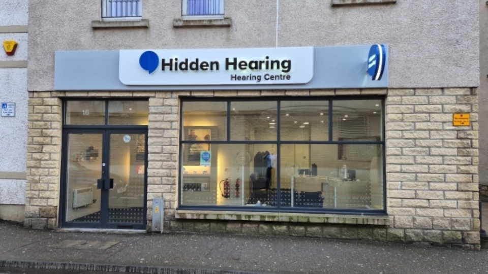 Exterior view of Hidden Hearing clinic in Inverness, featuring the clinic’s signage and large front windows.