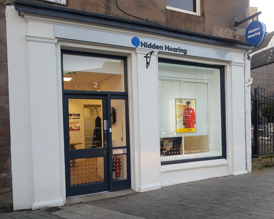 Hidden Hearing clinic storefront in Perth with a modern design and large window display featuring promotional materials.