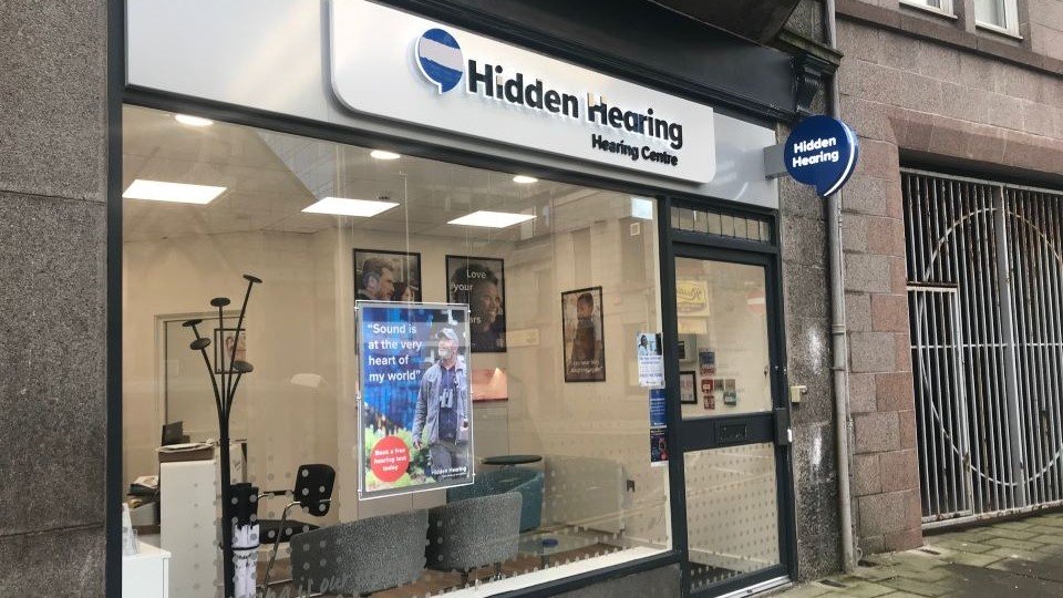 Hidden Hearing Aberdeen clinic storefront with clear signage and glass windows displaying posters.