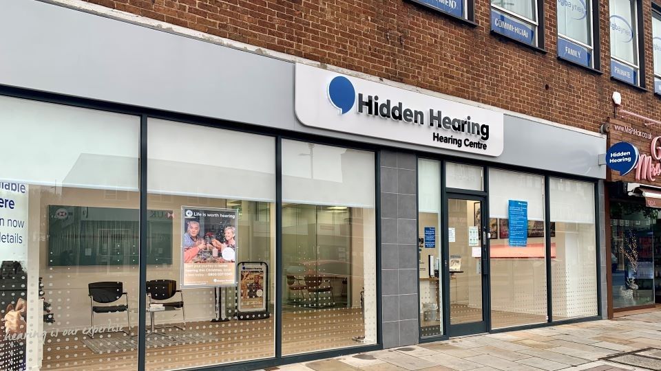 Exterior view of Hidden Hearing clinic in Bexleyheath, featuring a modern storefront with large windows and signage.
