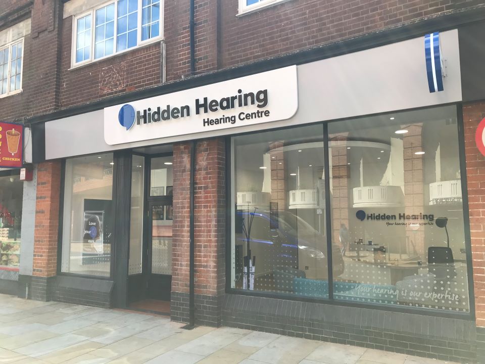Exterior of Hidden Hearing clinic in Ipswich, featuring large windows and branding.