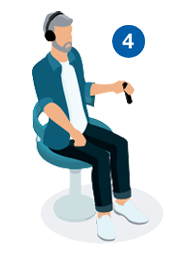 Man sitting on a chair wearing headphones, holding a response button during a hearing test.