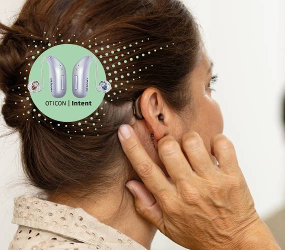 A lady wearing Oticon Intent hearing aids