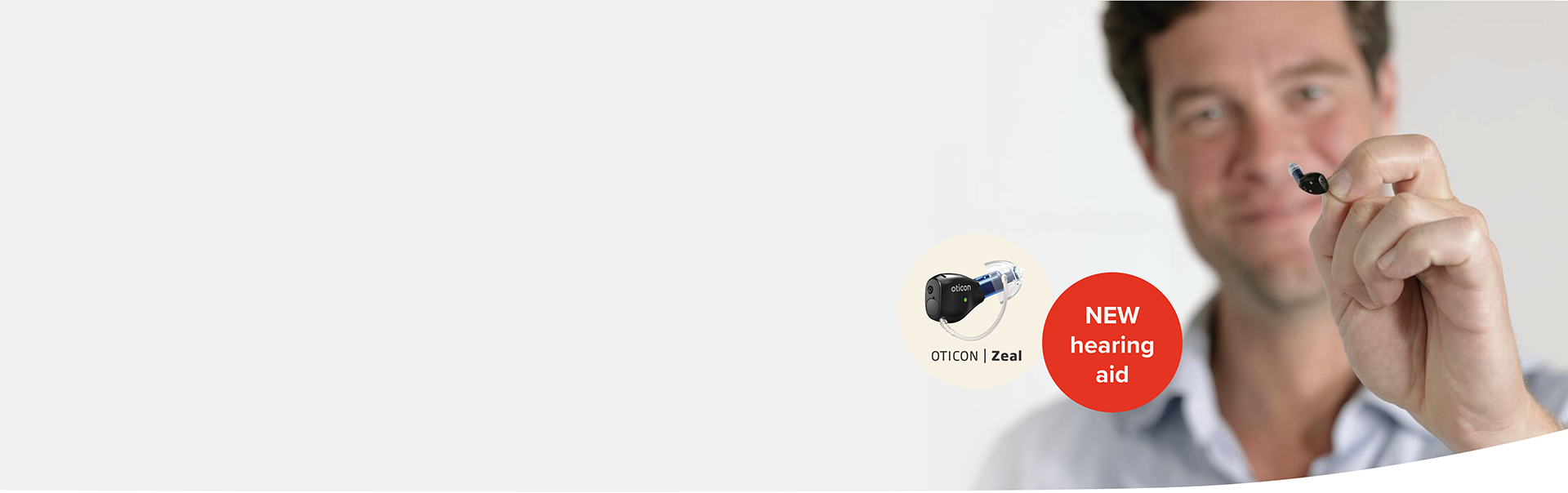 Man showcasing the Oticon Zeal hearing aid.