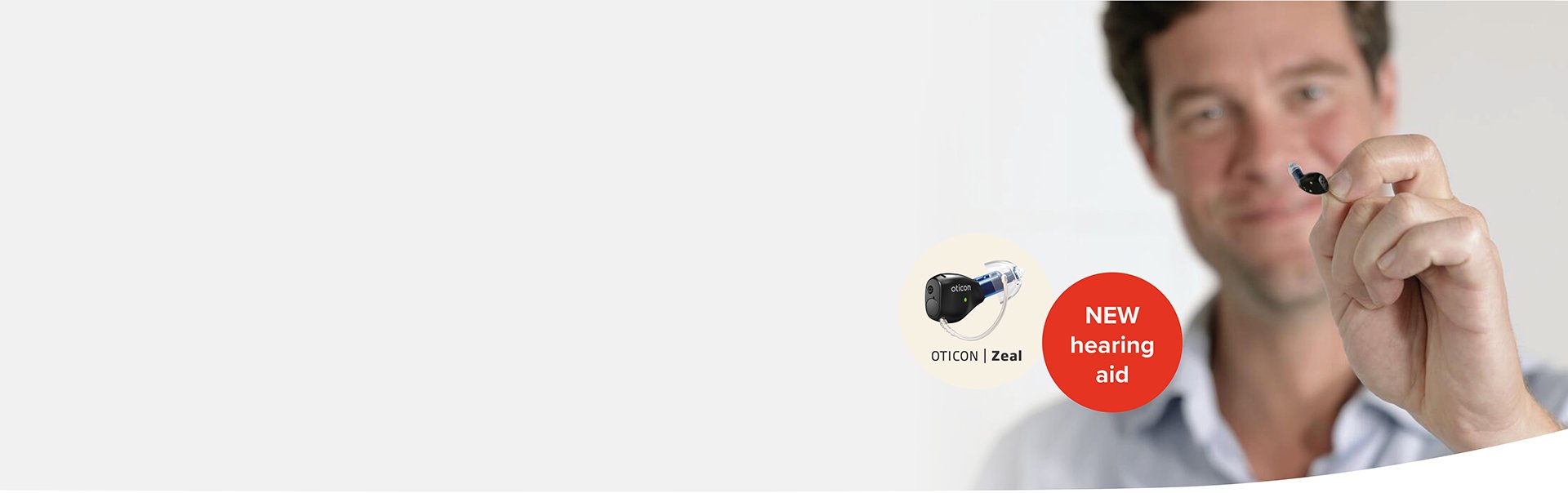 Man showcasing the Oticon Zeal hearing aid.