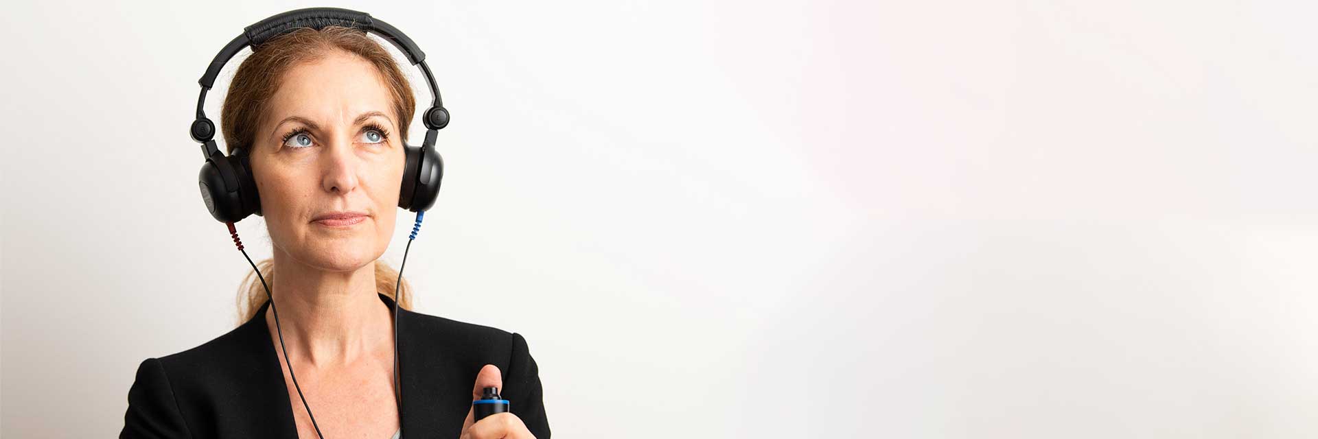 Woman wearing headphones during hearing assessment