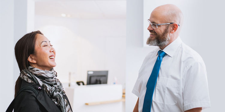 Image shows a hearing care expert talking with a customer