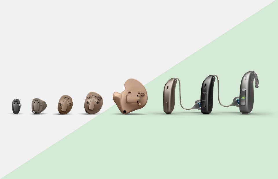 Range of hearing aids showcasing various types, including in-the-ear and behind-the-ear models, displayed on a two-tone background.