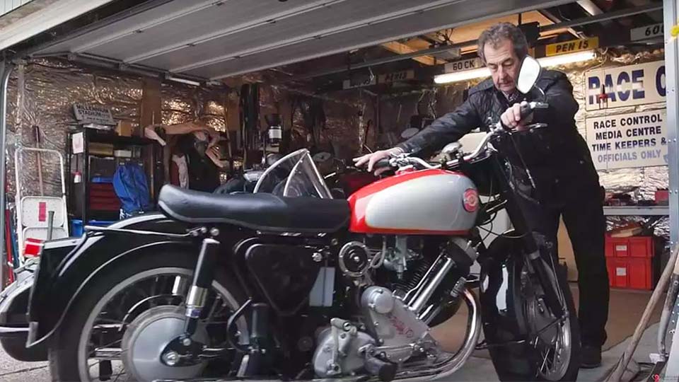 Steve Parrish with his motorcycle at a garage, showcasing his passion for motorbikes.