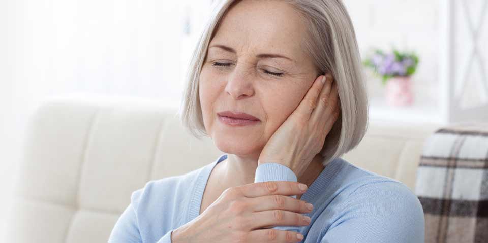 Woman touching her ear due to discomfort from a fungal ear infection