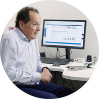 Image shows an audiologist discussing hearing test results