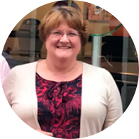 CFBH ambassador Christine Wright standing outdoors wearing a patterned top and white cardigan.