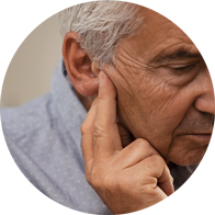 Man experiencing pain or discomfort in his right ear, possibly related to hearing loss.