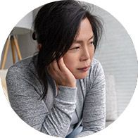 Woman experiencing symptoms related to conductive hearing loss