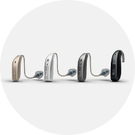Different styles and colors of modern hearing aids shown in a row.