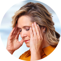 Woman holding her head in discomfort, indicating tinnitus symptoms