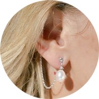 Hearing aid jewelry accessory featuring a pearl screw design with a delicate chain attachment