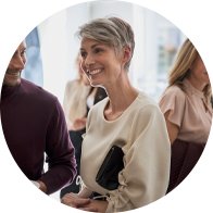 Woman in a social setting wearing digital hearing aids.