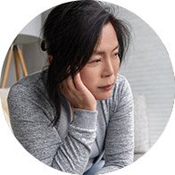 Woman experiencing symptoms related to conductive hearing loss