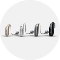 Different styles and colors of modern hearing aids shown in a row.