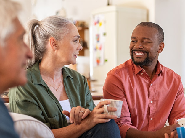 Image shows a woman feeling lost in a conversation because of untreated hearing loss