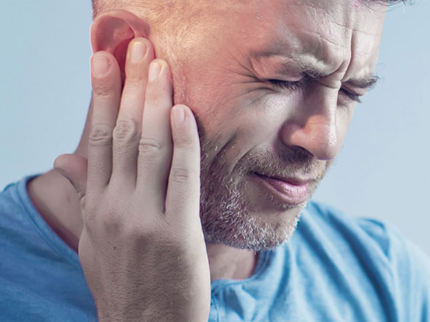 man experiencing hearing discomfort