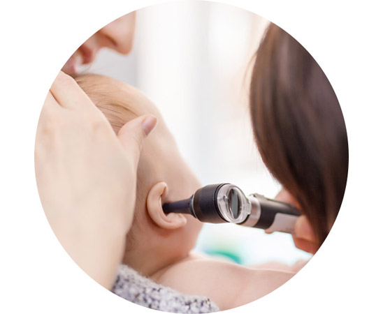 Audiologist conducting a hearing examination on a baby’s ear