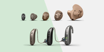A selection of hearing aids is displayed, featuring discreet in-ear models and behind-the-ear styles with connecting tubes, set against a split green and white background.