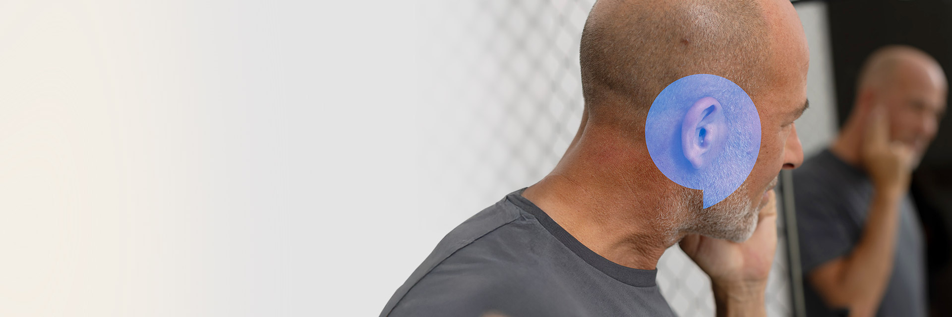 Man in sequined jacket adjusting a hearing aid in front of a mirror with text ’Keep hearing & dancing.’