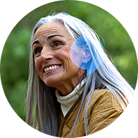 Senior woman outdoors with focus on ear and hearing health.