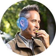 Middle-aged man outdoors with focus on ear and hearing concept