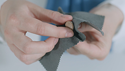Cleaning Oticon in-the-canal custom hearing aids with a microfiber cloth