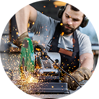 Image shows man working with a loud tool