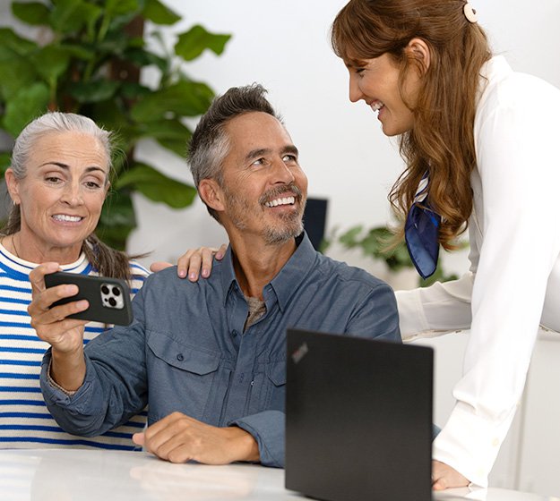 Man consulting with a hearing care specialist while holding a smartphone