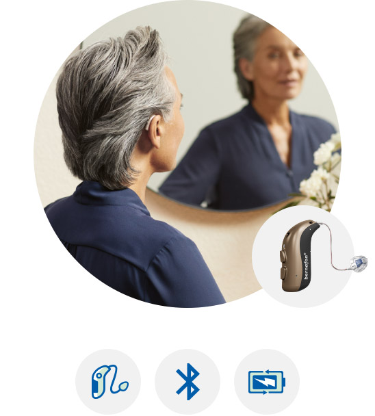 Image shows woman looking at herself in the mirror.