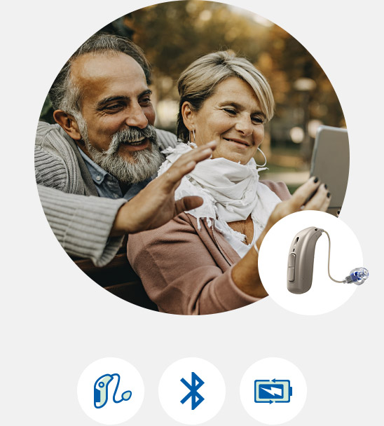 Image shows couple smiling looking at a tablet